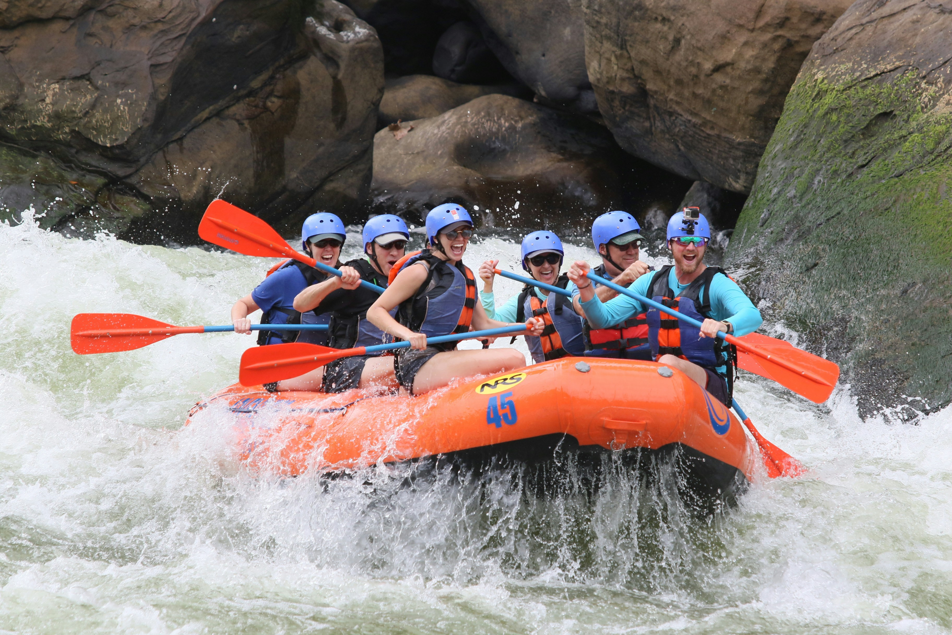 group of people white water rafting with hawks nest rafting
